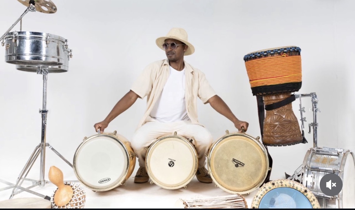 Musicien entouré de percussions et instruments traditionnels